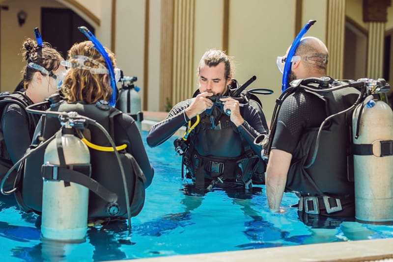 Instructor teaches students to dive